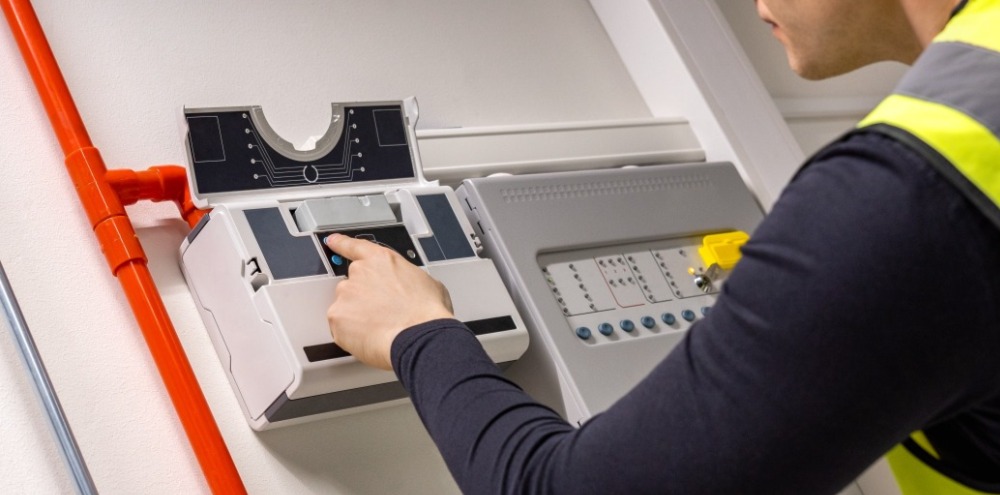INFINITI Fire Technician Servicing a managed NHS sites' Vesda System.