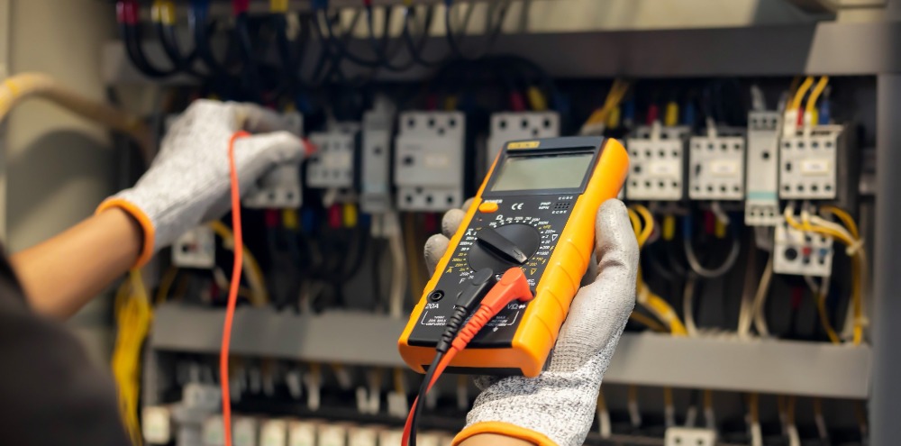 INFINITI Electrician testing local switchboard during a planned service visit.
